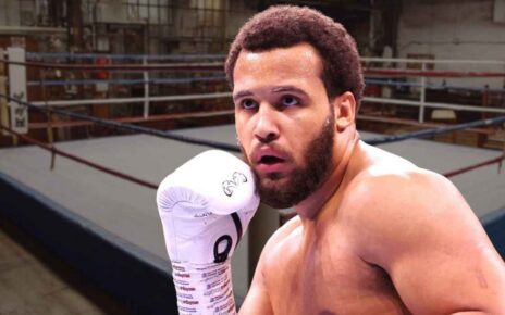 Boxer wearing gloves inside a boxing ring during a training session