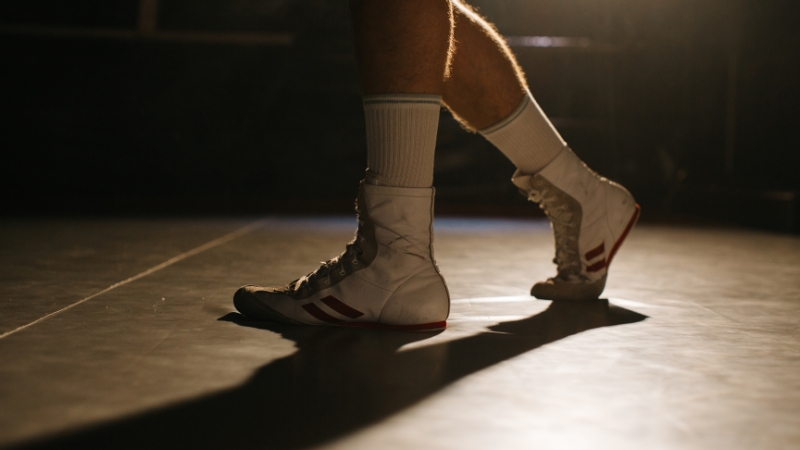Boxer steps lightly on the balls of the feet to maintain balance and speed during footwork drills