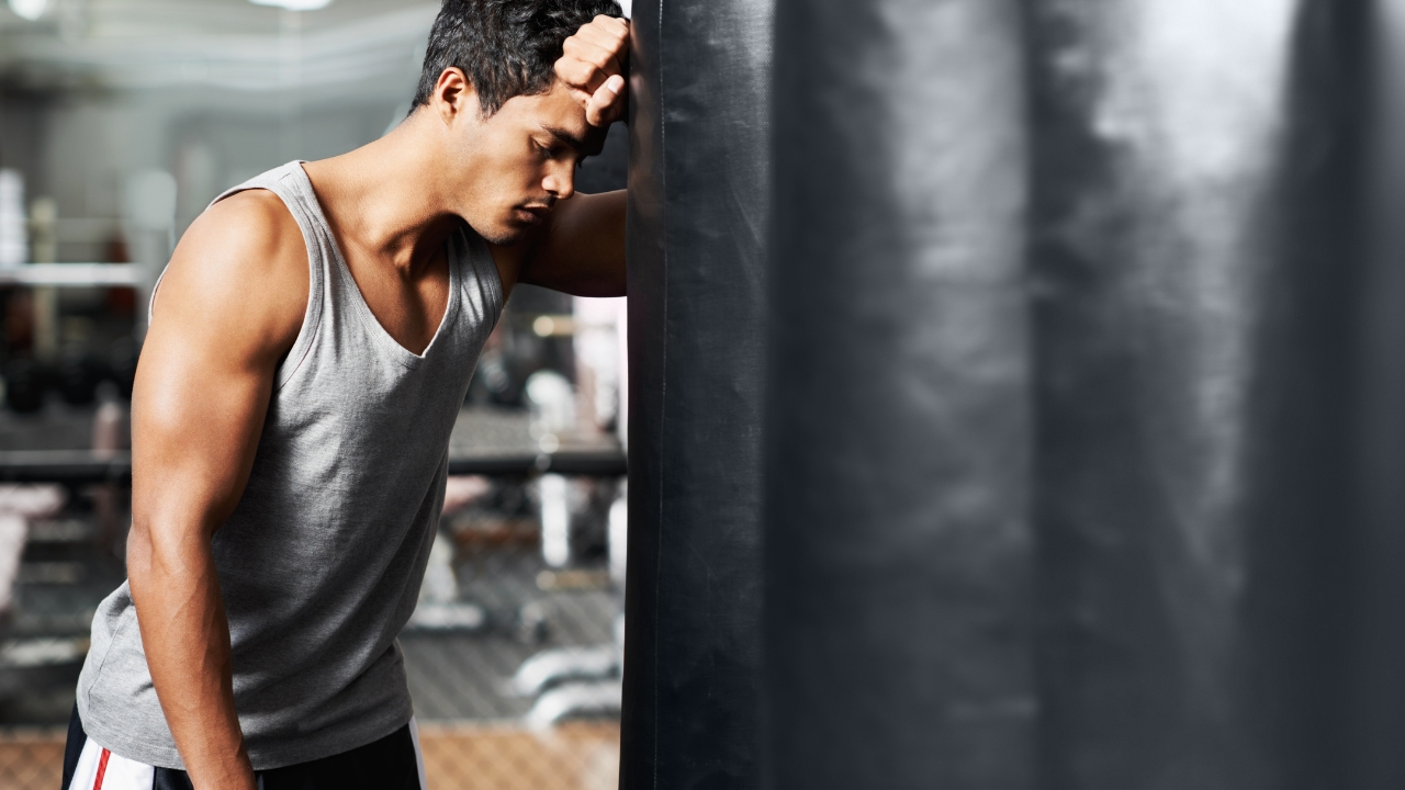 Man resting after intense HIIT workout, showing fatigue that affects EPOC response